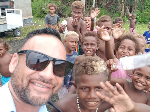 Inspector Darren Paki with local children during his time in the Solomon Islands.