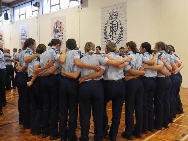The recruits with their arms wrapped around each other.