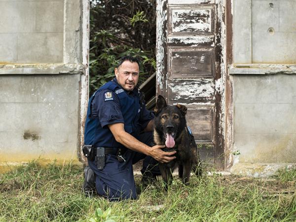 Comrie and his previous police dog Harlo. Picture credit: Dog Squad/TVNZ