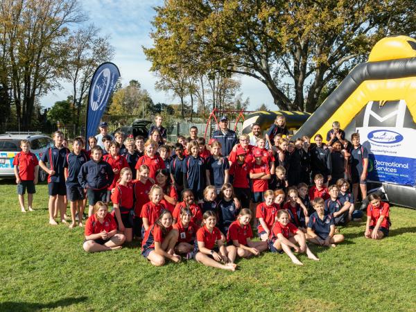 Police staff and pupils gathered in front of the obstacle course. 