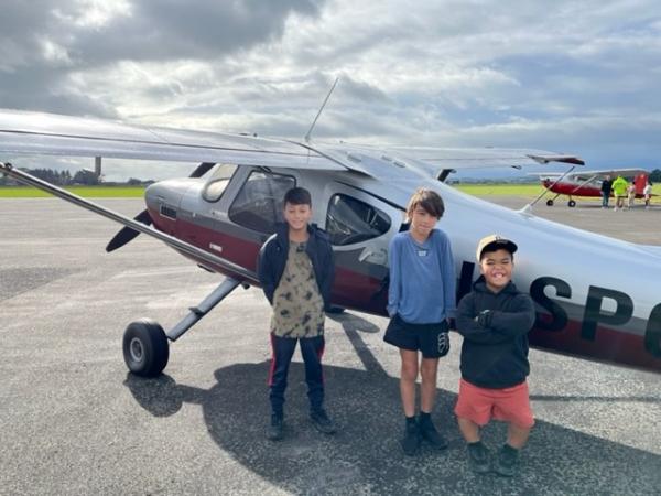 Some of the excited young passengers getting ready for their flight experience.