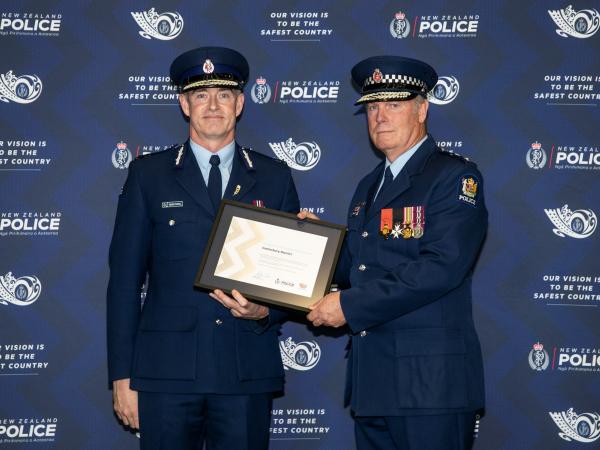 Commissioner Andrew Coster and Superintendent John Price with the certificate of commendation for Canterbury District.