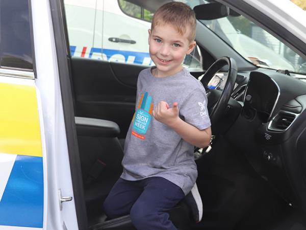 Carter tries out a police car for size.