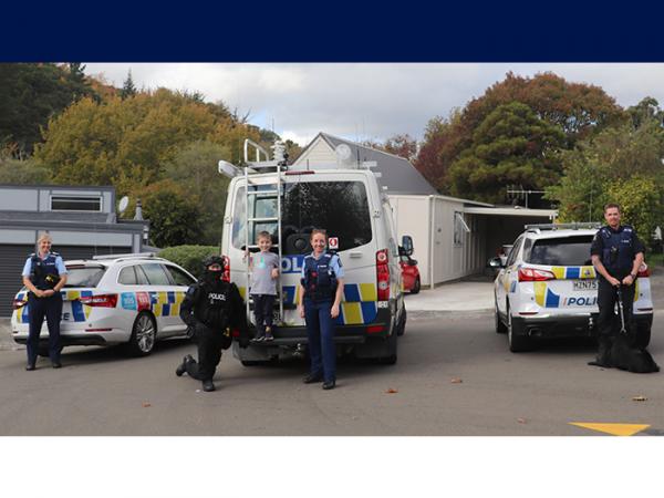 Carter with the officers and their Police vehicles. 