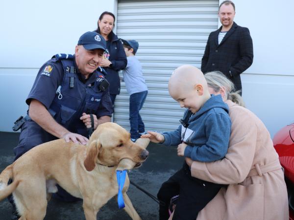 Introductions: Senior Constable Gary Donnelly and detector dog Rivet meet Willy and his mum Sarah.
