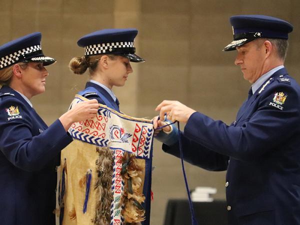 First in Wing Constable Lucy Bean has the Police korowai tied by Police Commissioner Andrew Coster.