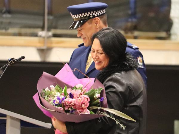 Wing Patron Arihia Stirling QSM with flowers presented to her by Leadership Award winner Constable Alfred Houghton.
