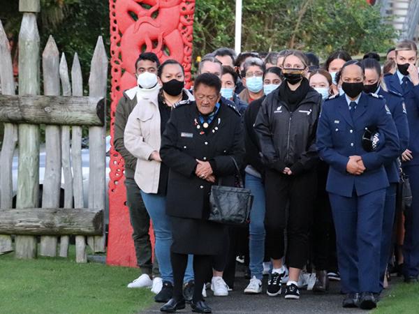 A group of 20-30 people being welcomed onto Waiwhetu Marae.