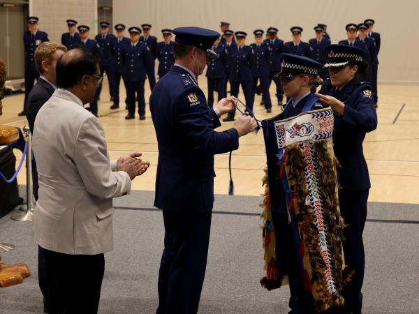 First in wing Constable Jaymie King has the RNZPC korowai put over her shoulders.