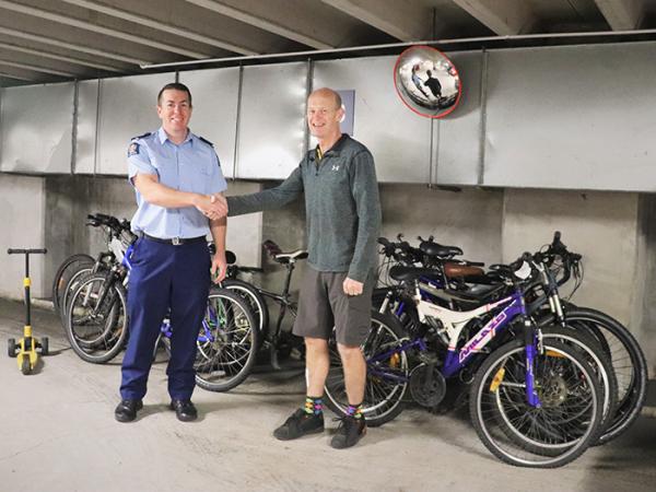 Senior Sergeant Shaun Richardson handing over the bikes to a representative of Bike Auckland.