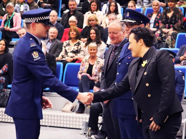 Second in Wing Constable Gavin Roos shaking hands with Minister of Justice Kiritapu Allan.