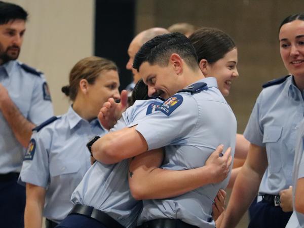 Constables hugging after the graduation 