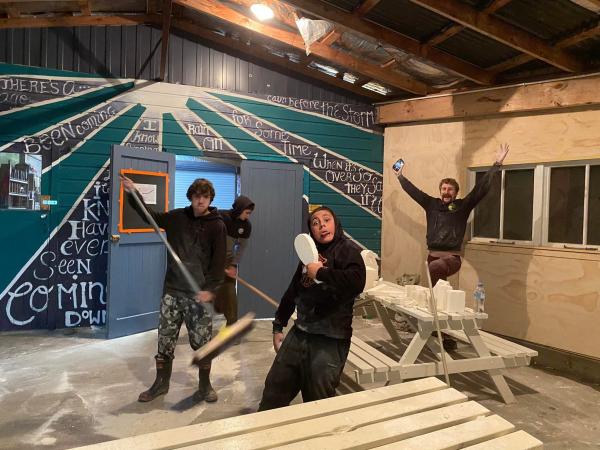 Constable Tim White (right) and some of the boys cleaning up after a carving session.
