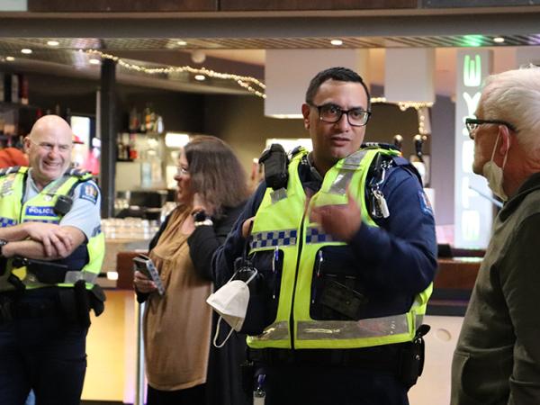 Sergeant Pat Tangipo and Senior Constable Stu Blake in conversation with people at Tuesday night's meet up.