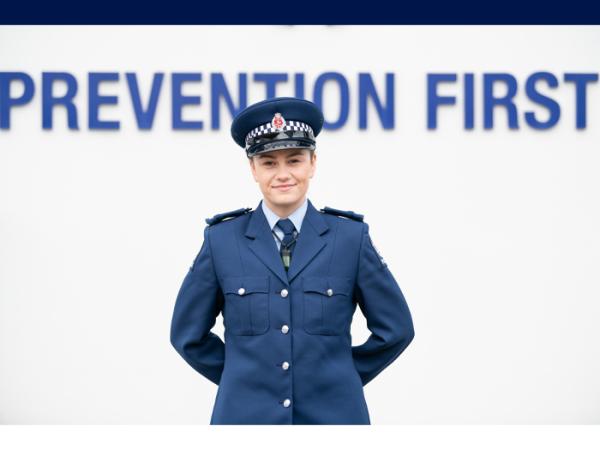 Constable Sam Nash in front of a Prevention First sign 