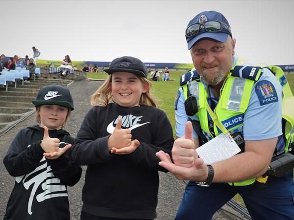 Senior Constable Darron Goodwin with two young rugby fans.