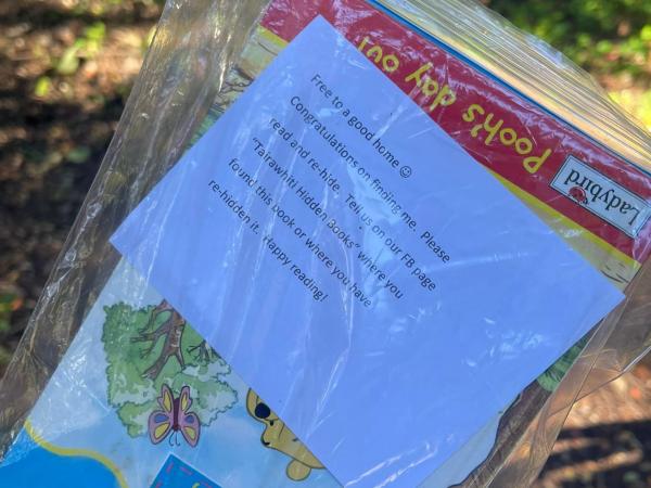 A copy of the note included with each book telling the recipient the book is free to take home and they’re welcome to re-hide fo