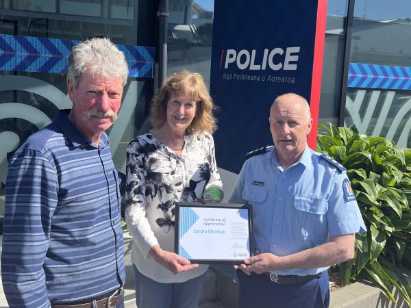 Inspector Marty James presents a certificate of appreciation to Sandy Ibbotson, pictured with her husband Brook.