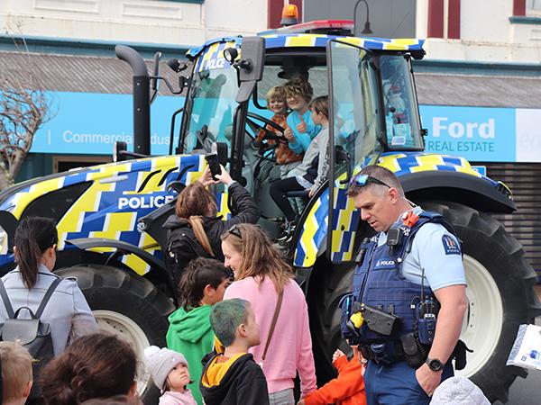 Constable Anthony (Trev) Thomas speaks with some kids about the tractor.