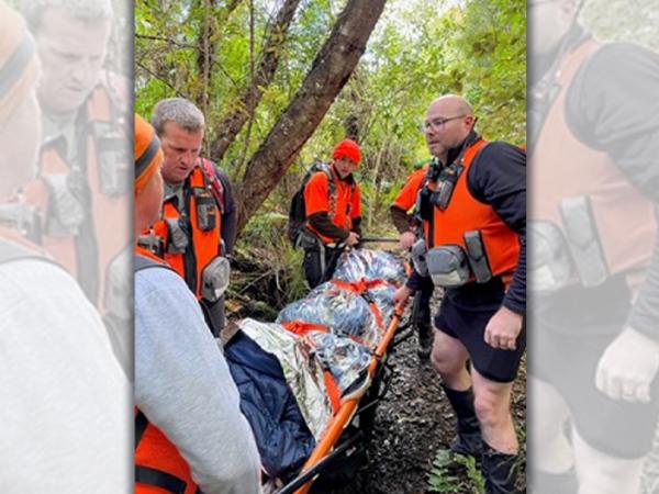 Some of the rescue team using the mule stretcher to transport Sam out of the bush. 
