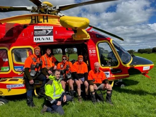 Group shot of some of the rescuers by the helicopter. 