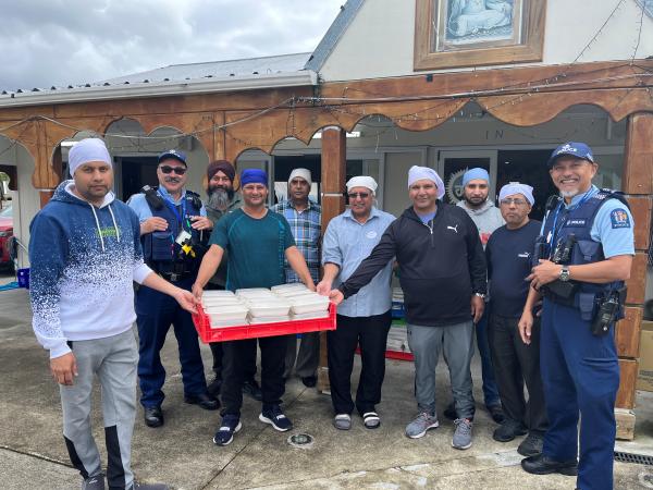 Senior Constable Pehitane Potaka and Sergeant Ding Capunitan at the Shri Guru Ravidass Temple with volunteers.