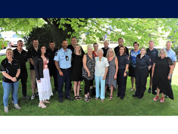 Brenda (centre, white top) surrounded by her family and members of the community who helped save her life.