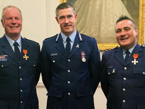 ...and his investiture as an Officer of the New Zealand Order of Merit (ONZM) in 2021, with Commissioner Coster and fellow award