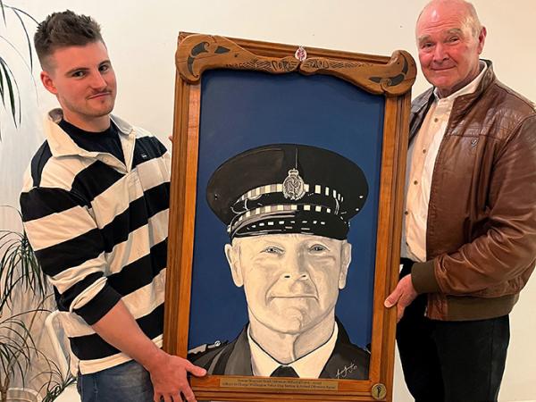 Dog handler Constable Jordan Steegh gifted Mark a portrait he had painted on his retirement.