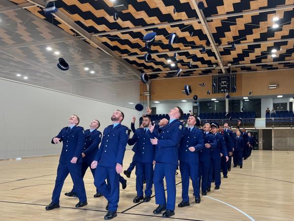 Constables of Wing 363 throwing their hats in the air. 