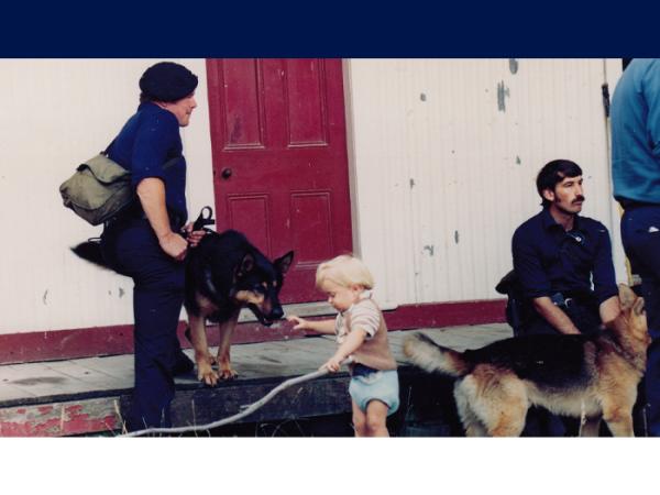 Mark with Nova and colleague Al Campbell with Pacer - and a small, unconcerned child - at the end of an AOS training exercise.