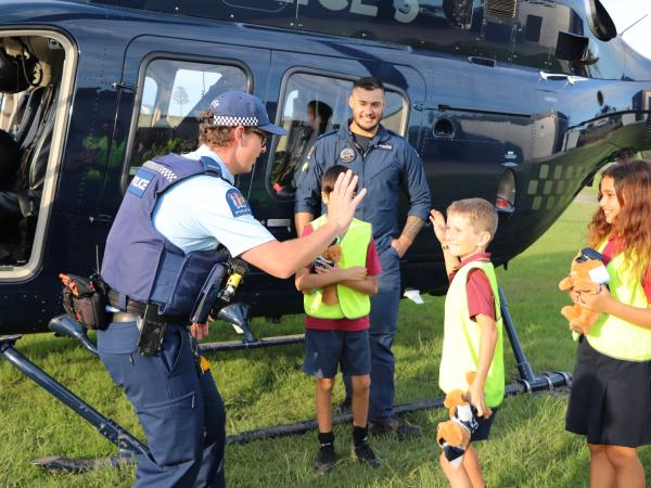 One of the officers high-fiving the students. 