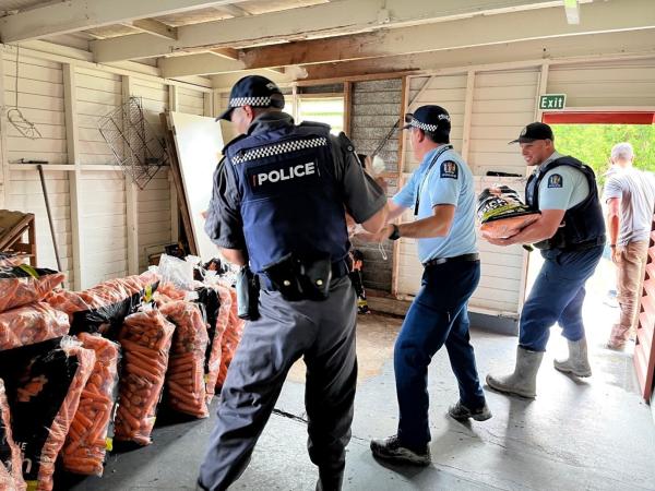 Sergeant Ben Joll (middle) pictured with his support crew unloading bags of carrots donated to Te Rawheoro Marae in Tolaga Bay.
