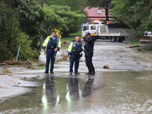 Constable Jacob Samuel (left) helping to deal with the 28 February floods.