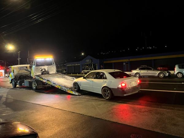A modified and unsafe car gets the tow treatment.