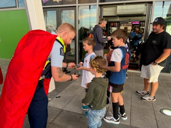 Road Policing Constable Andrew Crawford hands out goodies outside the stadium.