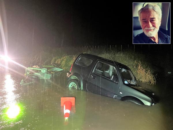 Bubs' vehicle and trailer swamped by floodwater, and an inset headshot of Albert Woodford. .