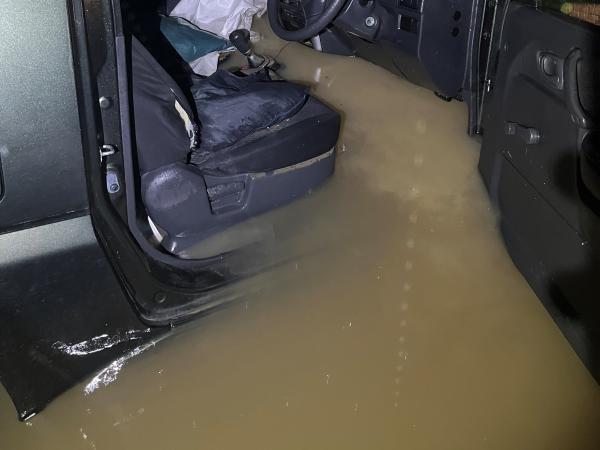 A photo showing floodwaters up to the steering wheel inside Bubs' vehicle. 