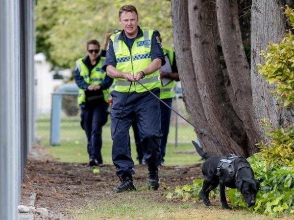 Sergeant Chris Harris and detector dog Floyd in action.
