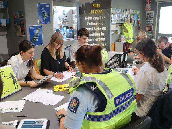 Senior Constable Chris Leppien and teachers work with students to prepare them for their learner's licence test.