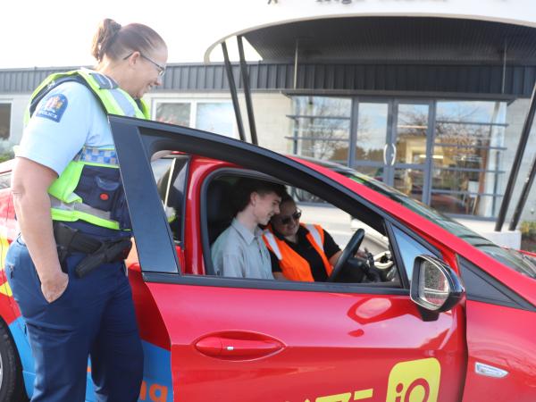 Chris with a student and Drive IQ instructor preparing for a driving lesson.