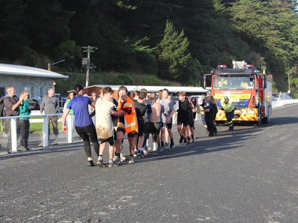 Supporters cheer the team in the fire engine pull, one of 15 events in The Longest Day.