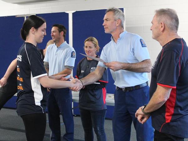 Kaikōura OC Sergeant Matt Boyce, awarding the Top Senior Female award to Zoe Boyce.