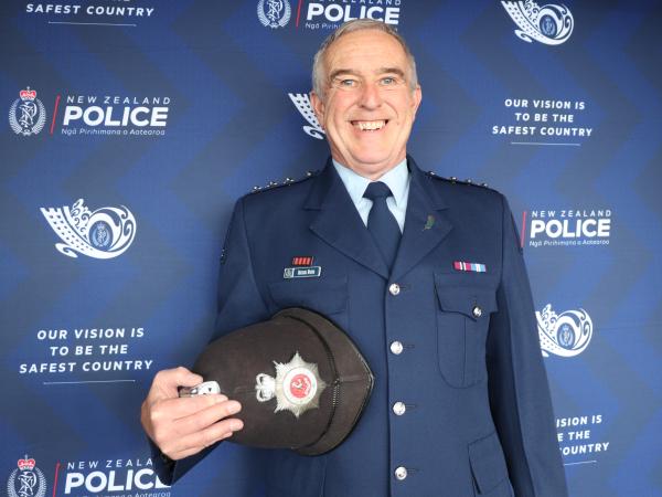 Inspector Mick Woods with one of the UK Police 'Bobby hats' he brought with him to Dunedin.