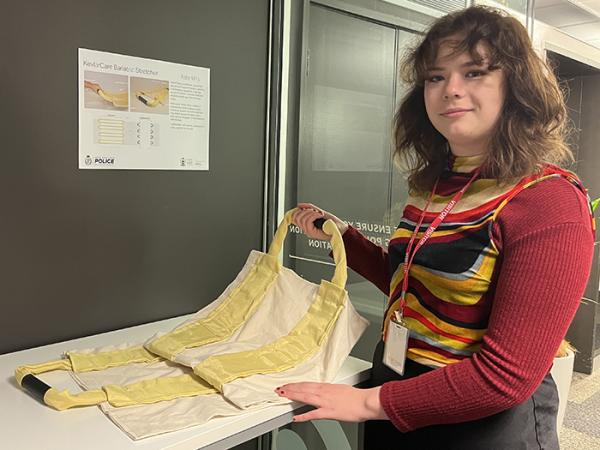 Kate Mills with a section of a stretcher she designed to support heavier patients.