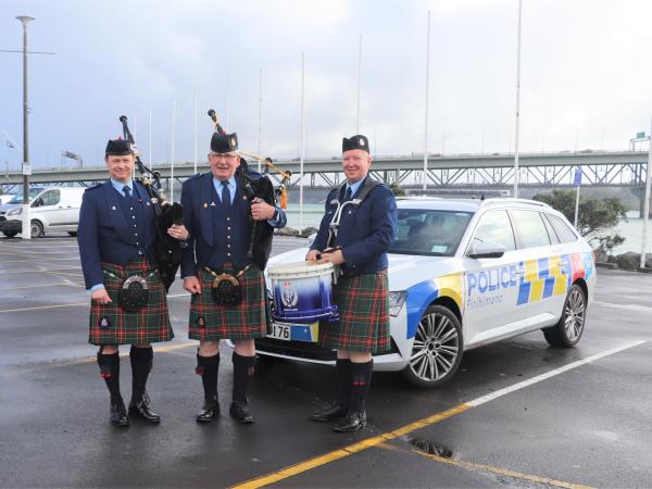 Group shot of Detective Senior Sergeant Chris Allan, Pipe Major Stewart Hobson and drummer Nic Norris in their band uniform.