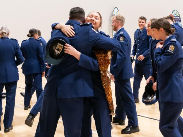 Wing 369 constables hugging after their graduation.