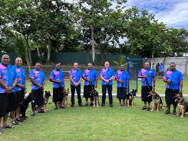 Sergeant Wally Kopae (fourth from left) and Inspector Todd Southall (fourth from right) with the new dog teams.