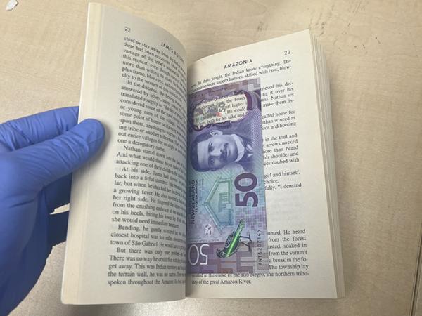A $50 note hidden between the pages of one of the novels.