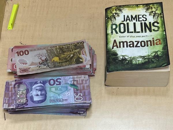 One of the novels and cash recovered.